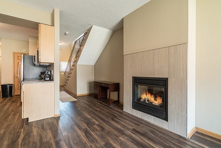 Cozy fireplace and hardwood-style flooring at Southwind Villas in La Vista NE